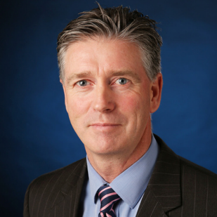 A photograph of Rod Duxbury on blue background