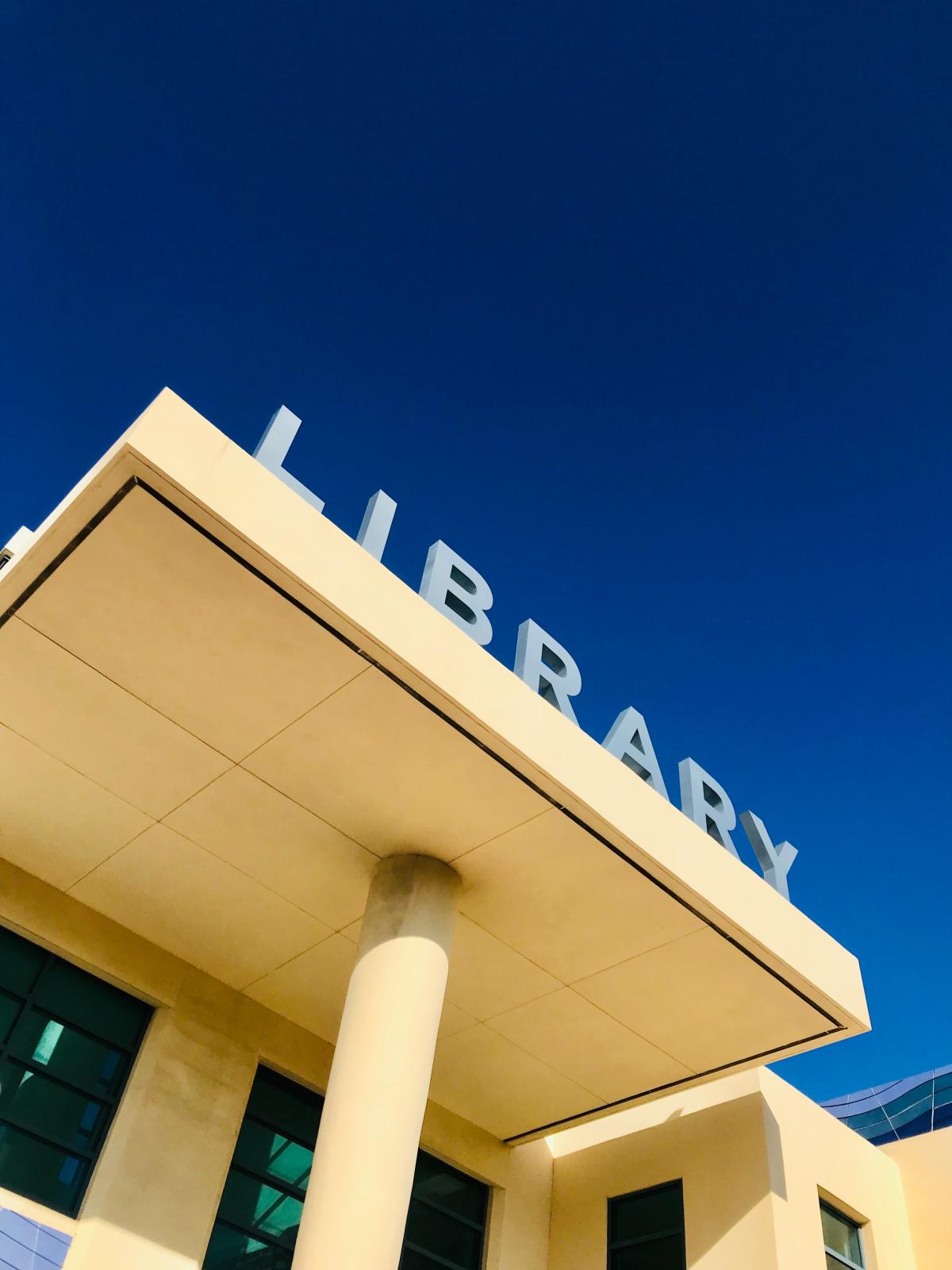 picture of library building entrance and sign