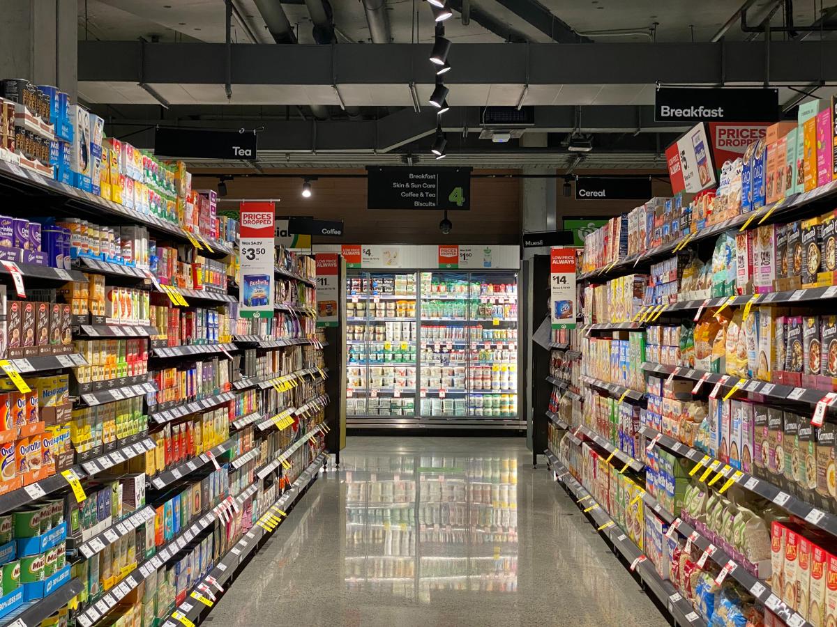 image of grocery store aisle with shelves full of food