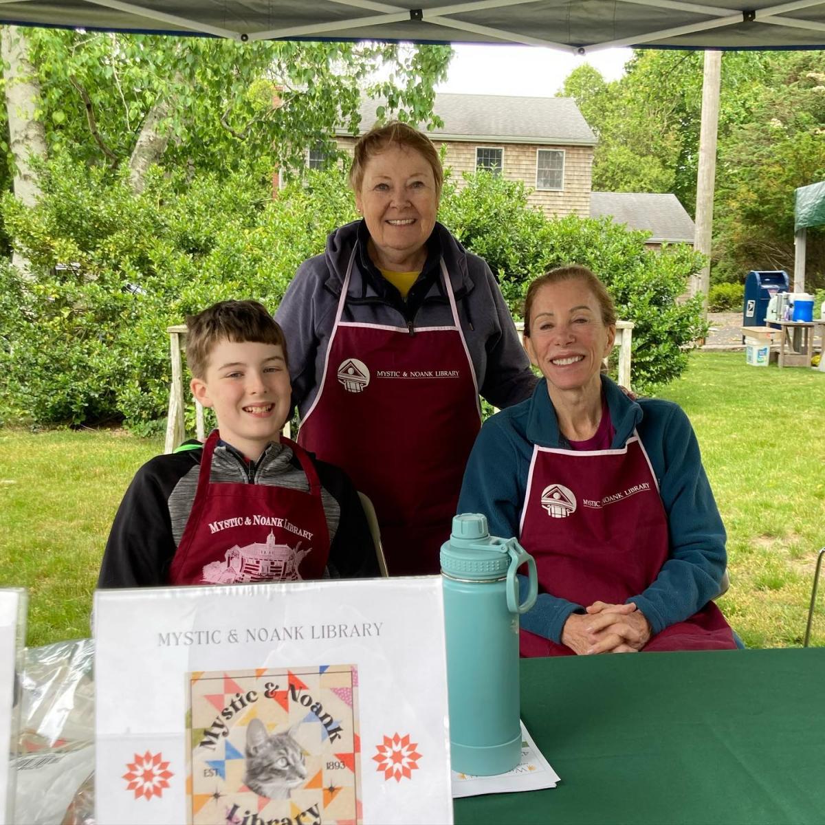 photo of director, trustee, and family member at friends fair