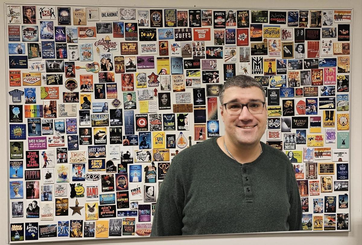 A photo of Brain Stoll, presenter, with playbills in the background.