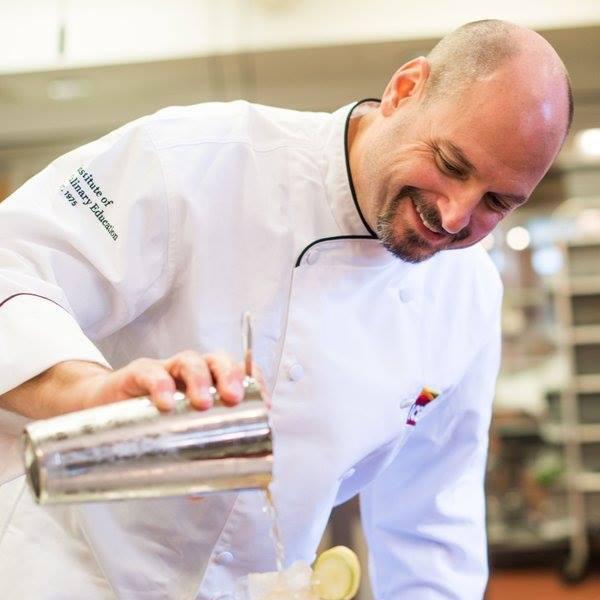 Smiling man making mocktails